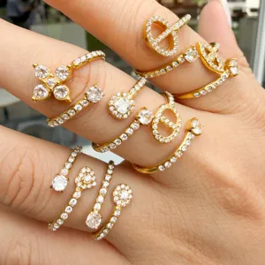 Gold-tone stainless steel ring set with sparkling cubic zirconia, shown stacked on fingers