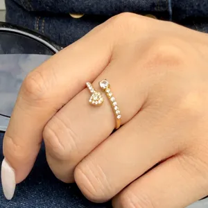 Gold-plated stainless steel open ring with heart and round stones, shown worn on a hand