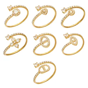 Seven gold-tone open rings with clear stones in assorted geometric, floral, and heart designs