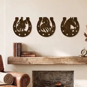 Three dark wood-look horseshoes with cowboy, horse and horse-head cutouts hang above a fireplace.