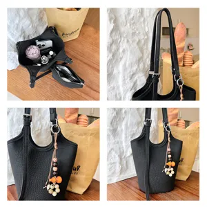 Detalles del bolso negro: relieve de cocodrilo, correa ajustable, interior y colgante de cuentas