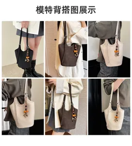 Seis vistas de bolsos tipo cubo llevados al hombro, efecto cocodrilo, en negro, marrón y beige