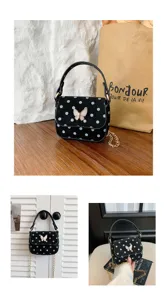 Black bag with blue and white dots and butterfly clasp, shown on a wooden table and in use