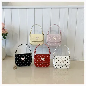 Five small handbags in yellow, pink, black, red and white, with dotted flaps and butterfly clasps