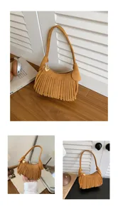 Brown suede-texture bag with dense fringe, short handle, zip closure and heart-shaped metal charm