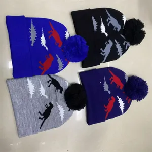 Four pom-pom knit hats with dinosaur jacquard patterns in blue, black, gray, and deep purple