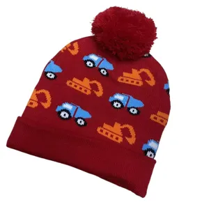 Red children's knit beanie with pom-pom, folded cuff and colorful car and excavator patterns