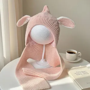 Pink rib-knit fabric, floppy bunny ears and attached neck wrap displayed on a white mannequin