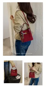 Lifestyle views of burgundy bucket bag with gold clasp, braided strap and wooden bead charm