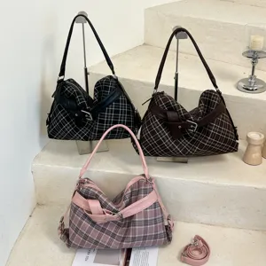 Three plaid bags in black, brown, and pink, shown together with shoulder straps and buckle details