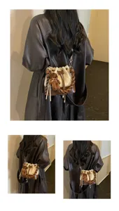 Back view of a brown and cream bucket bag with woven handles, teddy charm and adjustable strap