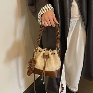 Beige suede-look bucket bag with brown leather base, braided handle, drawstring and teddy charm