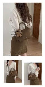 Lifestyle view of a brown suede-look bag worn over the shoulder, with a teddy bear charm