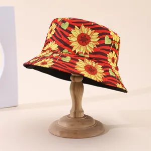 Reversible bucket hat on a wooden stand, with red zebra stripes, sunflowers and green hearts