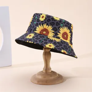 Purple leopard-print bucket hat with yellow sunflower motifs, displayed on a wooden stand