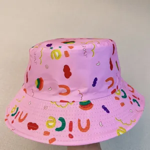 Close-up of colorful food and letter prints, including “NICE,” across a pink bucket hat.