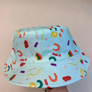 View of colorful playful letter and macaroni prints across pale blue bucket hat fabric