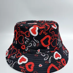 Close-up of red and white heart doodles and “love” text across the black fabric surface