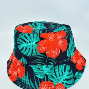 Dark fabric shows tropical teal leaves and vivid red flowers on the crown and stitched brim