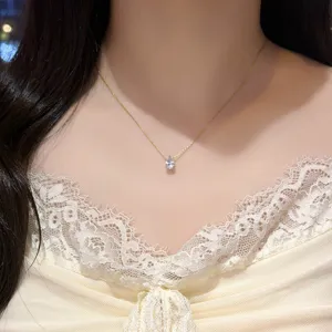 Delicate gold-tone necklace with a pear-cut clear zirconia pendant, shown worn at the neck