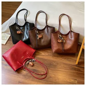 Vier Kunstledertaschen in Schwarz, Braun, Dunkelbraun und Bordeaux, mit Bärenanhängern und Kette