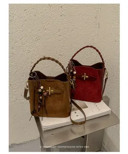 Brown and burgundy suede-look bucket bags with woven handles, gold T clasps and beaded tassels