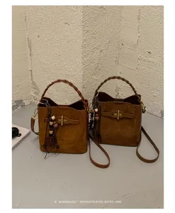 Two brown suede-look bags displayed together, with braided handles, shoulder straps and metal clasps