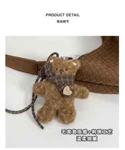 Gros plan sur un ours brun en peluche, foulard à carreaux et étiquette cœur, près d'un sac tressé
