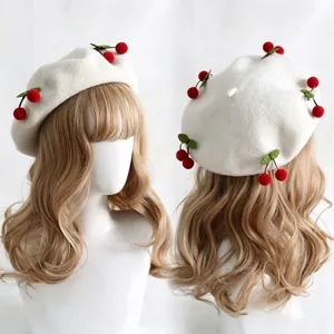 White felt beret with red cherry and green leaf accents, shown from front and back angles
