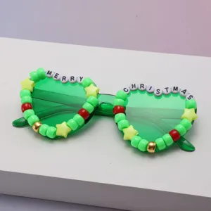 Green sunglasses with star beads, red and gold accents, and Merry Christmas lettering