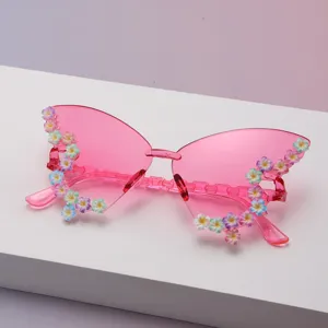 Rosa Schmetterlingsgläser mit Farbverlauf und bunten Blumen auf weißem Präsentationsblock