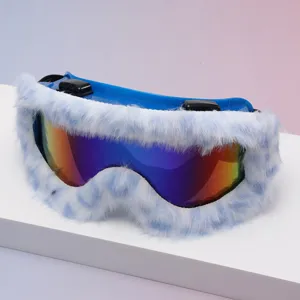 Close-up of rainbow reflective ski goggles with blue frame and soft white faux-fur trim