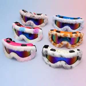 Six snow goggles with fluffy trim and mirrored rainbow lenses arranged on a soft pastel backdrop