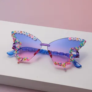 Close-up of colorful sprinkle beads and BIRTHDAY GURL lettering on blue-pink gradient lenses
