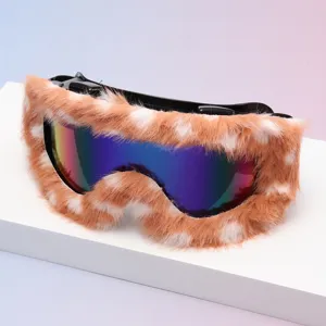 Studio view of ski goggles with fluffy brown-and-white trim and a rainbow mirrored lens
