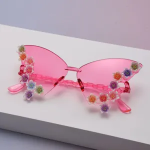 Close-up of pink butterfly sunglasses with glittery multicolor flower details on frames