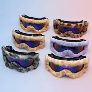 Six ski goggles with mirrored lenses and plush patterned trim arranged on a pastel background