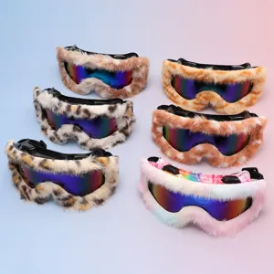 Six ski goggles arranged on a pastel background, with plush frames and colorful mirrored lenses
