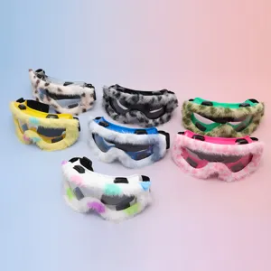 Seven colorful goggles with fluffy trim and dark lenses on a soft blue-pink background