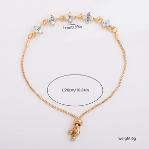 Flat lay of a gold-tone box chain with colorful rhinestone flowers and an adjustable slider clasp