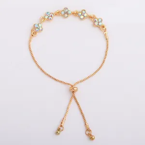 Flat-lay view of a gold-tone chain with multicolor four-petal rhinestone flowers and sliding clasp