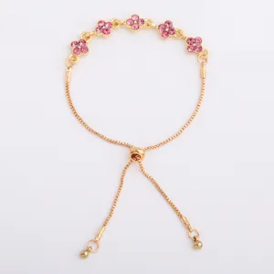 Flat lay showing five pink flower-shaped stones, gold-tone chain, and sliding bead clasp