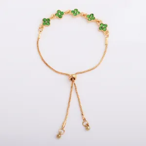 Gold-tone chain with green flower-shaped stones and sliding clasp, shown flat on white