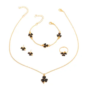 Gold-tone four-piece clover jewelry set with black enamel necklace, bracelet, earrings and ring