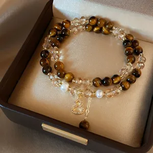 Bracciale a doppio giro con perle occhio di tigre, cristalli, perle e ciondolo dorato a zucca