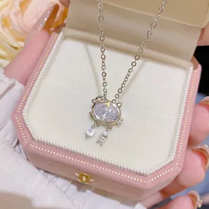 Silver cat-paw pendant with an oval clear stone and tiny fishbone charms in a pink jewelry box