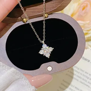Close-up of a flower pendant with sparkling white stones, displayed in a velvet-lined jewelry box