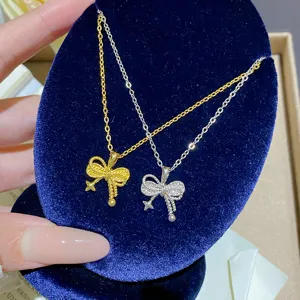 Close-up of gold and silver bow pendants with sparkling accents, star and bead charms on velvet