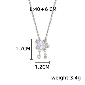 Detail view of a silver cat-shaped pendant with oval white zircon, dangling charms, and dimensions