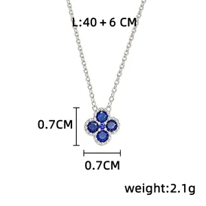 Close-up of a blue four-leaf clover pendant with silver-tone setting and size labels
